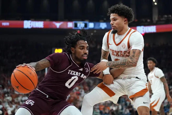 Jan 17, 2026; Austin, Texas, USA; Texas A&M Aggies guard Marcus Hill (0) moves the ball against Texas Longhorns guard Jordan Pope (0) during the first half at Moody Center. Mandatory Credit: Dustin Safranek-Imagn Images