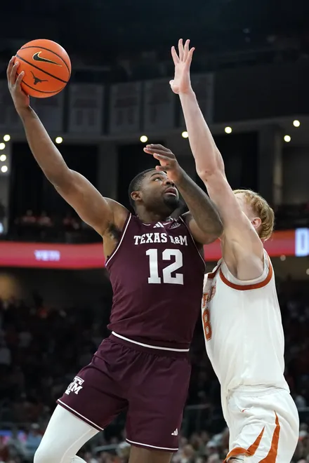 Jan 17, 2026; Austin, Texas, USA; Texas A&M Aggies forward Rashaun Agee (12) makes a lay up against Texas Longhorns center Matas Vokietaitis (8) during the first half at Moody Center. Mandatory Credit: Dustin Safranek-Imagn Images