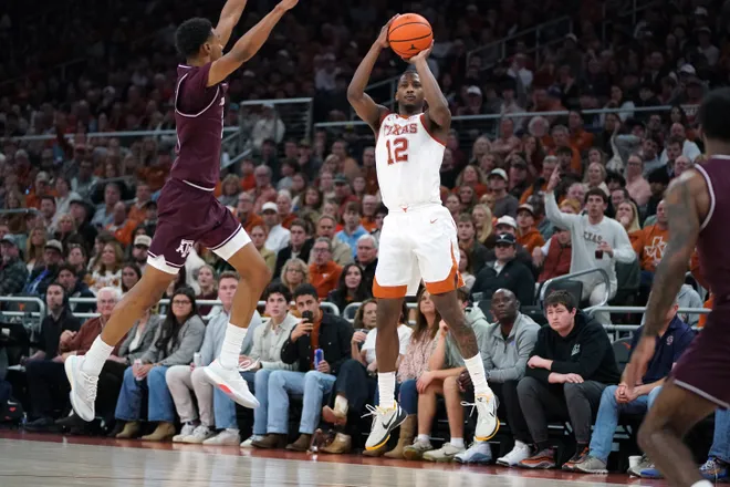 Jan 17, 2026; Austin, Texas, USA; Texas Longhorns guard Tramon Mark (12) shoots a three point basket against Texas A&M Aggies guard Ryan Griffen (3) during the second half at Moody Center. Mandatory Credit: Dustin Safranek-Imagn Images
