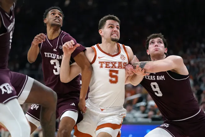 Jan 17, 2026; Austin, Texas, USA; Texas A&M Aggies guard Ryan Griffen (3) and guard Ruben Dominguez (9) block Texas Longhorns forward Camden Heide (5) during the second half at Moody Center. Mandatory Credit: Dustin Safranek-Imagn Images