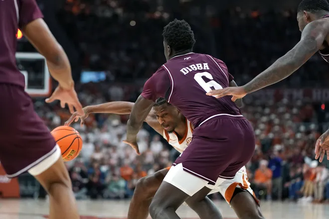 Jan 17, 2026; Austin, Texas, USA; Texas Longhorns guard Tramon Mark (12) drives the ball against Texas A&M Aggies guard Ali Dibba (6) during the second half at Moody Center. Mandatory Credit: Dustin Safranek-Imagn Images