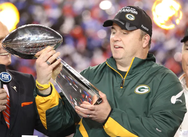 Feb 6, 2011; Arlington, TX, USA; Green Bay Packers head coach Mike McCarthy hoist the Lombardi Trophy into the air following Super Bowl XLV against the Pittsburgh Steelers at Cowboys Stadium. Mandatory Credit: Matthew Emmons-USA TODAY Sports