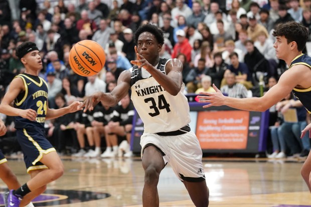 Kaneland's Jeffrey Hassan (34) passes the ball against Yorkville Christian during a Plano Christmas Classic Final game in Plano on Tuesday, Dec. 30, 2025. (Sean King / For The Beacon-News)