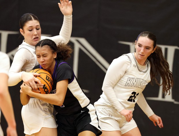 Kaneland's Kyra Lilly (21) watches teammate Kalie Brown (33) and Plano's Le'niya Viser (1) fight for a rebound in the second quarter during a non-conference game in Maple Park on Tuesday, Jan. 6, 2026.H. Rick Bamman / For the Beacon-News