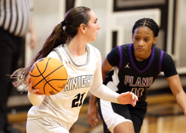 Kaneland's Kyra Lilly (21) looks to pass as Plano's Jadyn Long (11) defends in the third quarter during a non-conference game in Maple Park on Tuesday, Jan. 6, 2026.H. Rick Bamman / For the Beacon-News