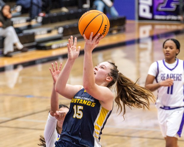 Yorkville Christian's Payton Wallin (15) finishes a layup against Plano during a nonconference game in Plano on Wednesday, Jan. 7, 2026. (Jeremy Toney / for the The Beacon-News)