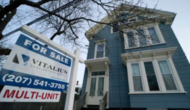 A sign announces a home for sale on Munjoy Hill, Wednesday, Jan. 25, 2023, in Portland. (AP Photo/Robert F. Bukaty)