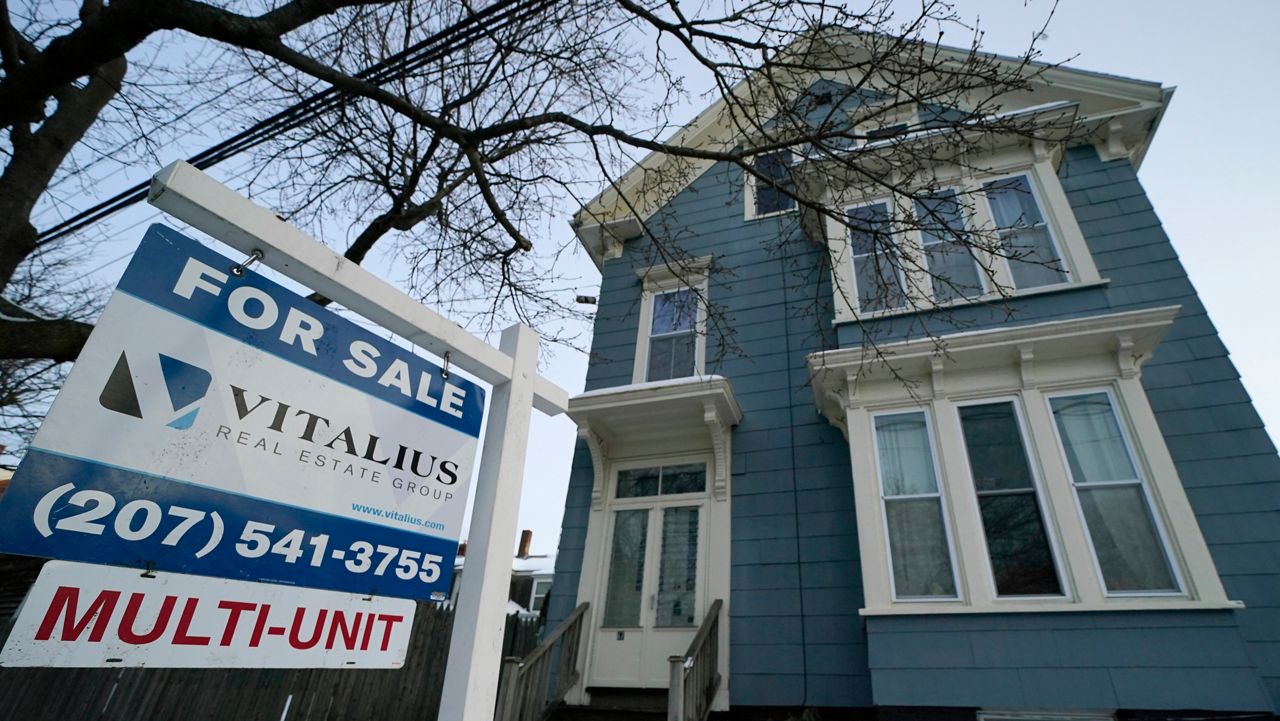 A sign announces a home for sale on Munjoy Hill, Wednesday, Jan. 25, 2023, in Portland. (AP Photo/Robert F. Bukaty)