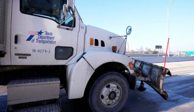 Texas Department of Transportation snow plows sit idle as a work crew, nearby, takes a lunch, Friday, Feb. 3, 2023, in Dallas. (AP Photo/Tony Gutierrez)