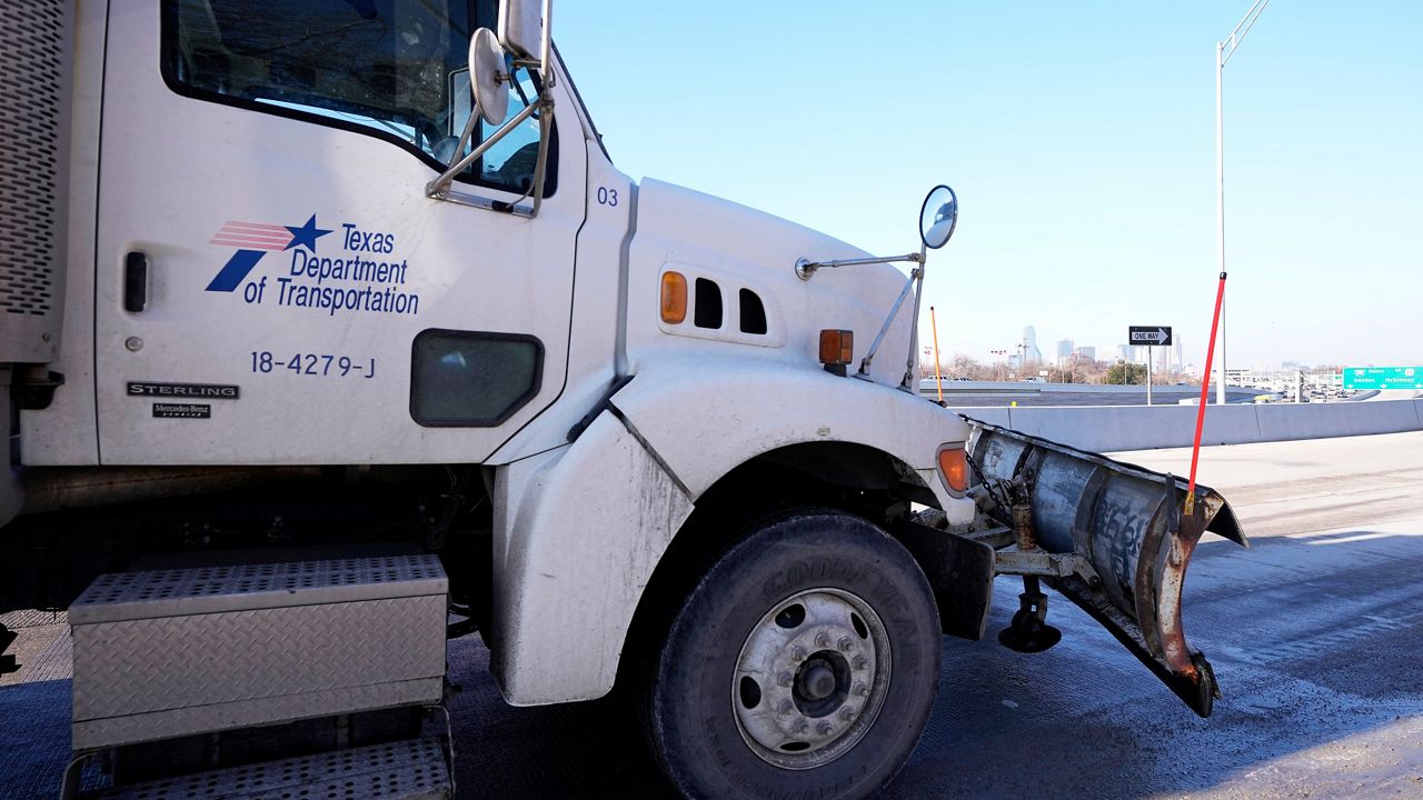 Texas Department of Transportation snow plows sit idle as a work crew, nearby, takes a lunch, Friday, Feb. 3, 2023, in Dallas. (AP Photo/Tony Gutierrez)