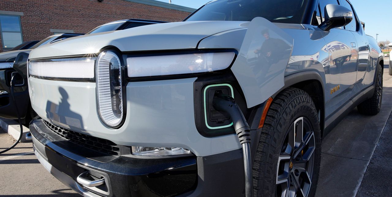 A 2023 R1T pickup truck is charged in a bay at a Rivian delivery and service center Wednesday, Feb. 8, 2023, in Denver. (AP Photo/David Zalubowski)