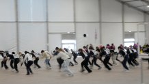 Volunteer dancers perform during rehearsals for the opening ceremony of the Milan Cortina 2026 Winter Olympic Games, at a compound in a big tent next to San Siro Stadium, in Milan, Italy, Saturday, Jan. 24, 2026.