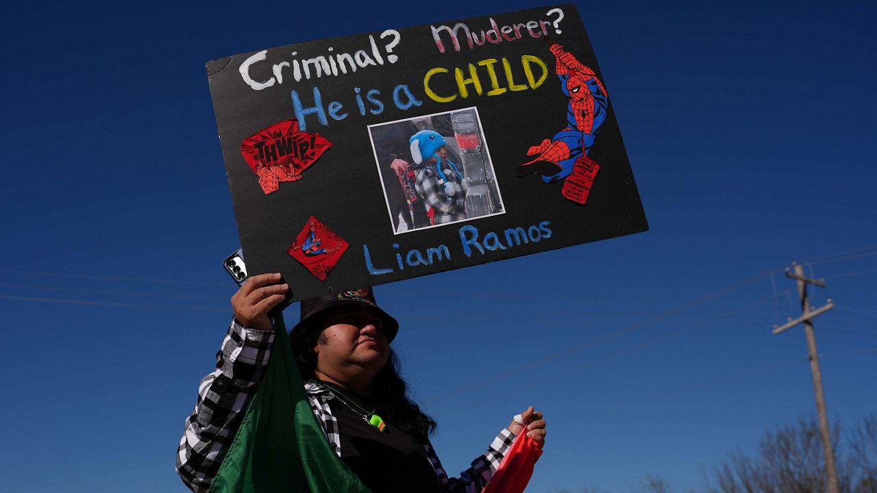 Protesters gather outside the South Texas Family Residential Center detention facility where Liam Ramos and his father are being detained in Dilley, Texas, Wednesday, Jan. 28, 2026. (AP Photo/Eric Gay)