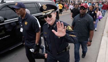 San Antonio Police Chief William McManus, center, joins thousands of walkers as they take part in a march honoring Martin Luther King Jr. in San Antonio, Monday, Jan. 16, 2023. (AP Photo/Eric Gay)