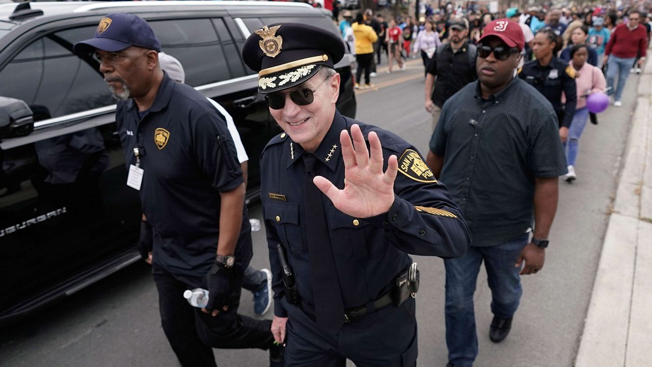 San Antonio Police Chief William McManus, center, joins thousands of walkers as they take part in a march honoring Martin Luther King Jr. in San Antonio, Monday, Jan. 16, 2023. (AP Photo/Eric Gay)