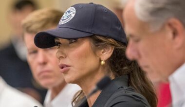 Homeland Security Secretary Kristi Noem, center, and Texas Gov. Greg Abbott, right, discuss the ongoing search and rescue efforts after recent flooding along the Guadalupe River during a press conference on Saturday, July 5, 2025, in Kerrville, Texas. (AP Photo/Rodolfo Gonzalez)