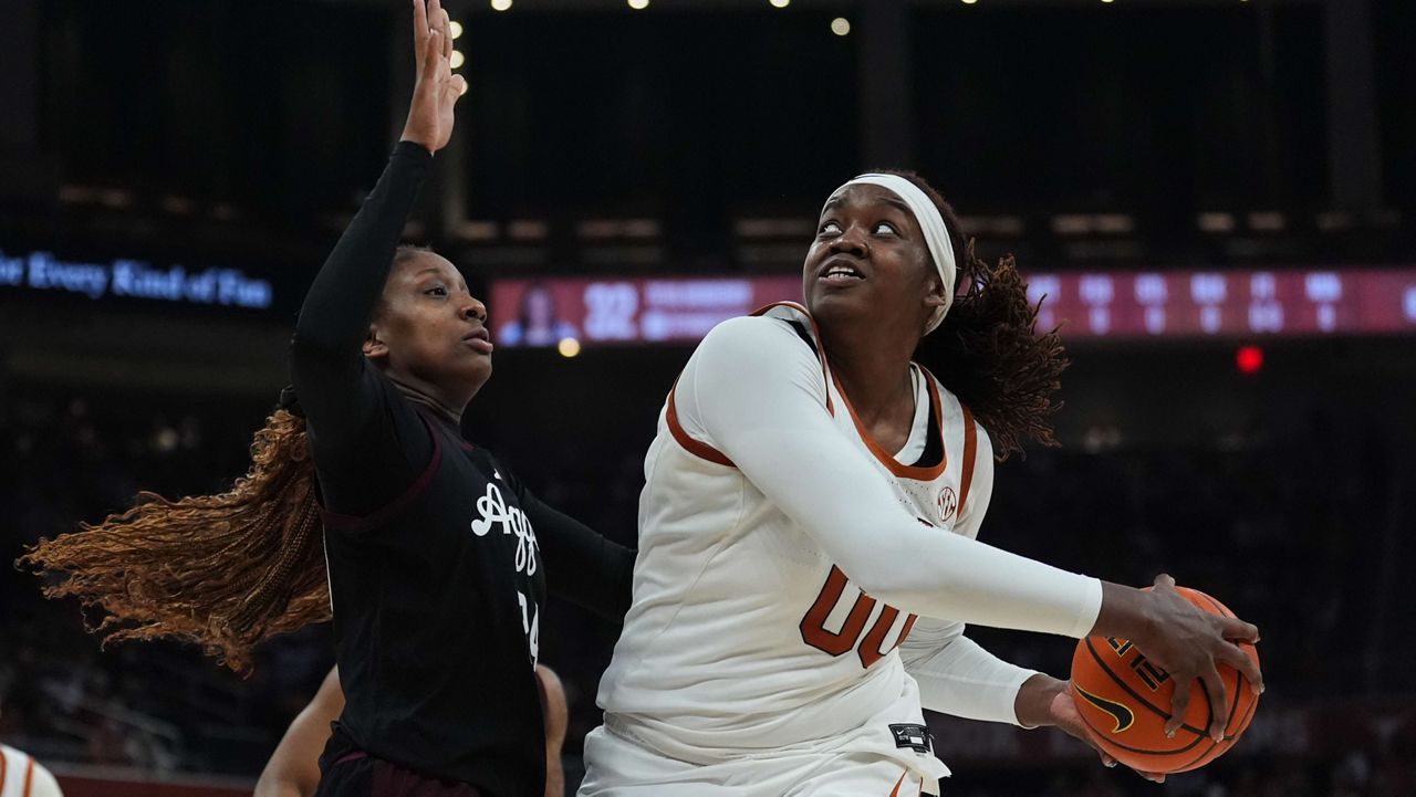 Texas center Kyla Oldacre (00) looks to shoot past Texas A&M center Emerald Parker (24) during the second half of an NCAA college basketball game in Austin, Texas, Sunday, Jan. 18, 2026. (AP Photo/Eric Gay)