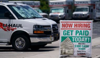 A sign at a UHaul store looking to hire employees is also offering a bonus, Thursday, May 20, 2021, in Boynton Beach, Fla. (AP Photo/Marta Lavandier)