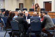 Dallas ISD Superintendent Stephanie Elizalde walks around tables filled with trustees and...