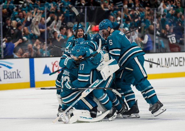 The San Jose Sharks dogpile over San Jose Sharks' Alex Nedeljkovic (33) after San Jose Sharks' Tyler Toffoli (73) scores the game winning goal against the Dallas Stars during overtime at SAP Center in San Jose, Calif., on Saturday, Jan. 10, 2026. (Shae Hammond/Bay Area News Group)