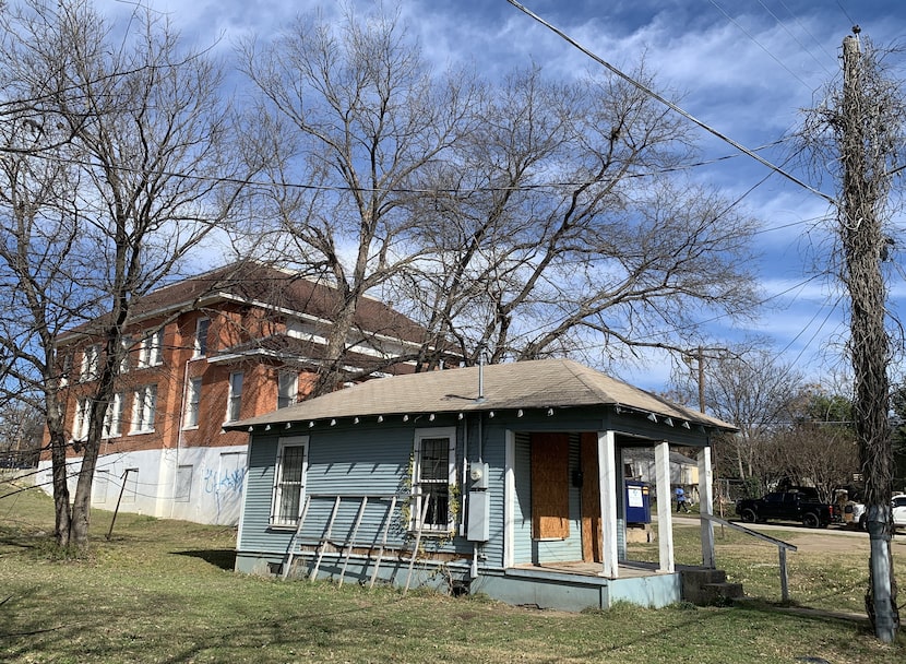 A shotgun shell of a house sits boarded up on the narrow Noah Street just behind the...