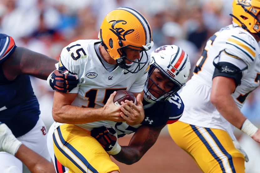 California quarterback Fernando Mendoza, center left, is sacked by Auburn defensive lineman...