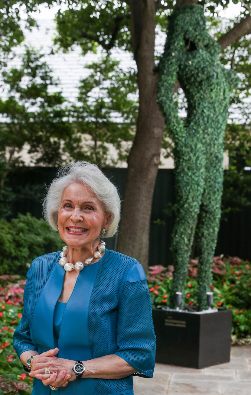 Linda Custard posed at her Dallas home in 2019 with her faux topiary, a whimsical gift from...