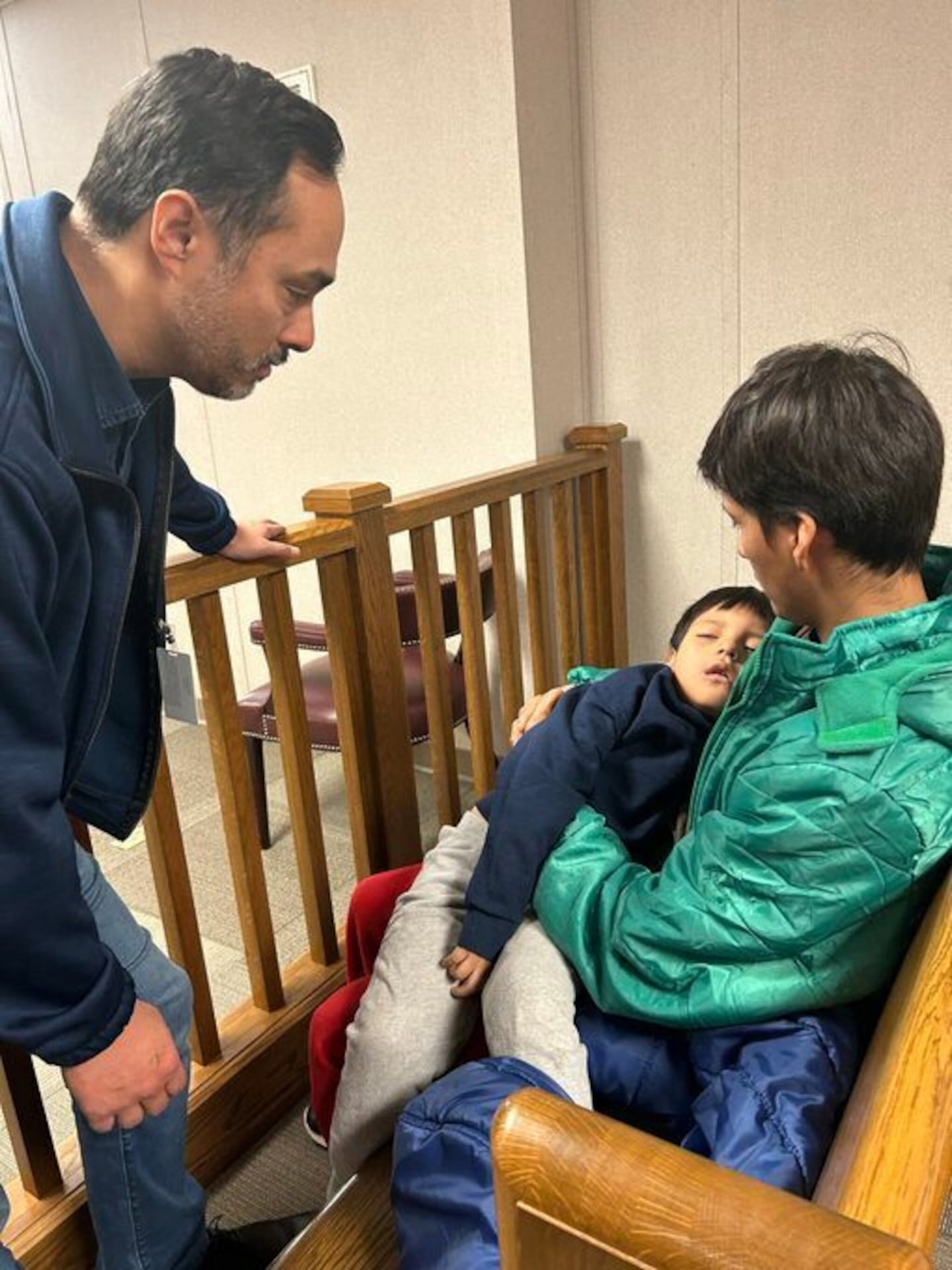 In this image provided by US Representative Joaquin Castro, Castro, left, visited with Liam Conejo Ramos and his father, Adrian Alexander Conejo Arias, on Wednesday.