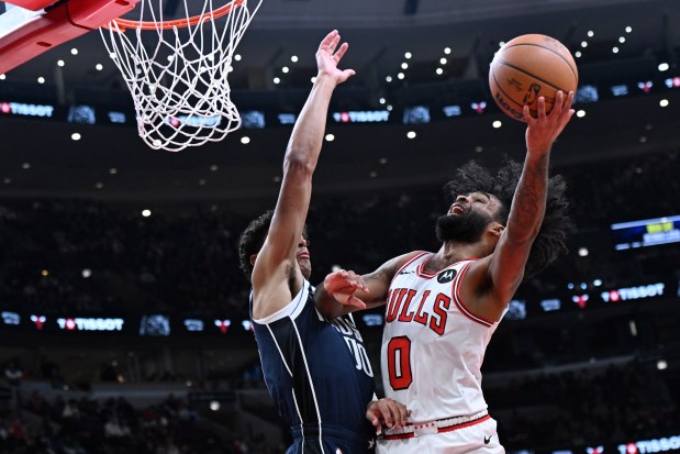Bulls guard Coby White (0) goes up for a shot against the Mavericks' Max Christie during the second half Saturday, Jan. 10, 2026, at the United Center. (Paul Beaty/AP)