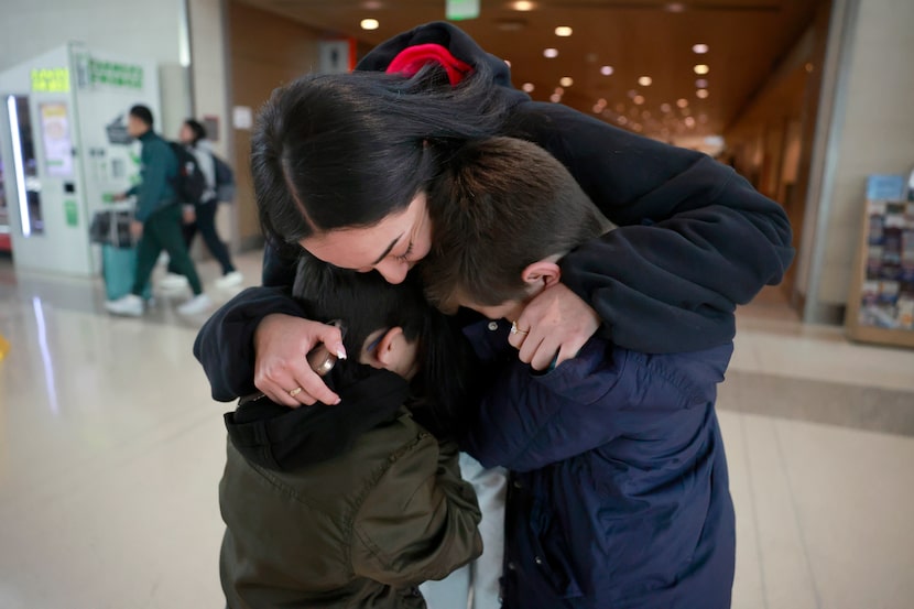 Southwest Airlines traveler Jaelyn Grimes is surprised by her brothers Julian Grimes (left)...