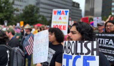 Man with sign calling to abolish ICE at Dallas No Kings protest.