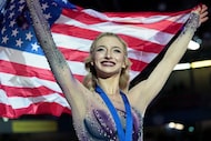 Amber Glenn, of the United States, poses after winning the gold medal in the women's event...