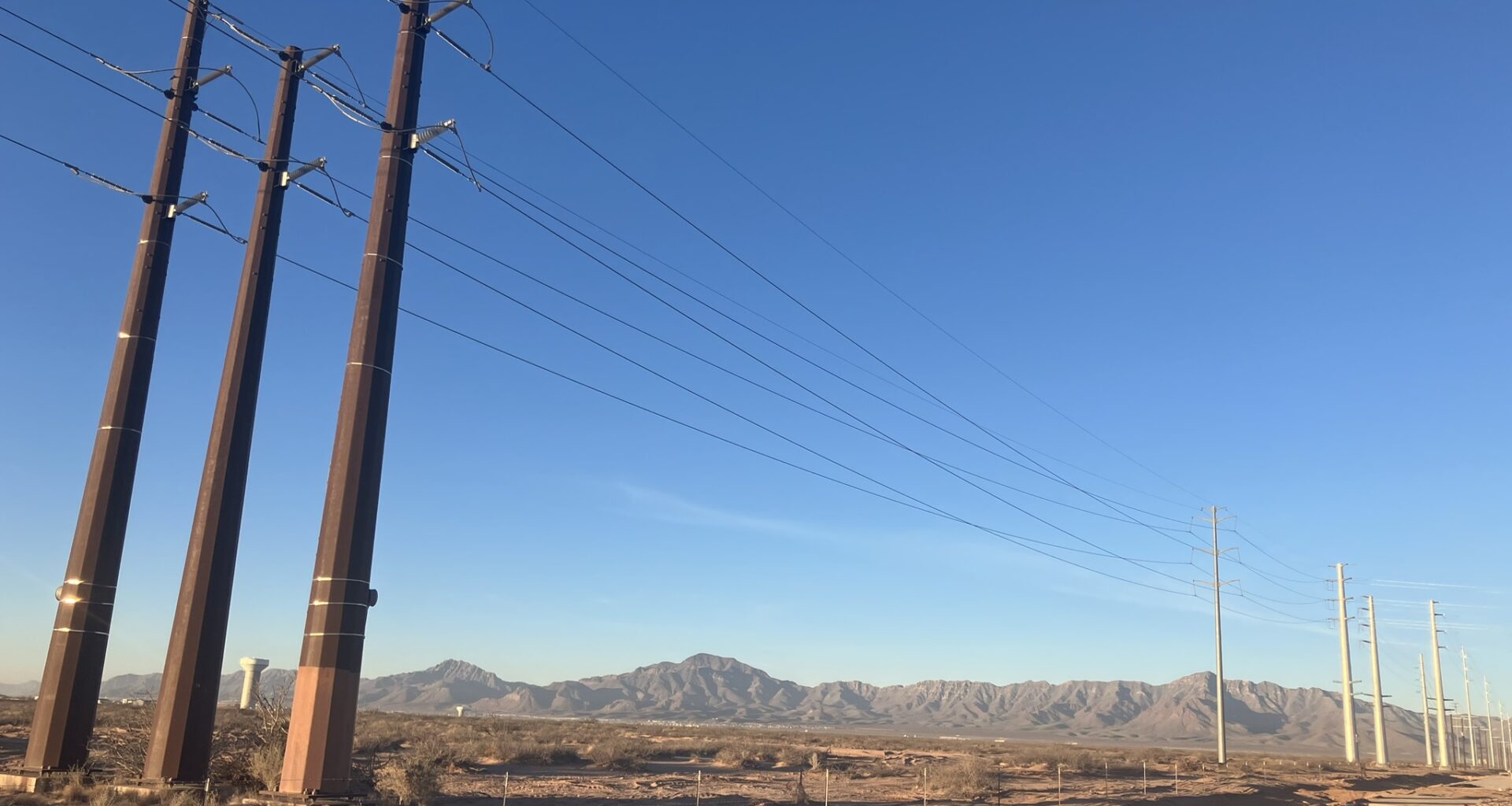 Transmission lines along Stan Roberts Sr. Avenue in Northeast El Paso, adjacent to the construction site of the Meta data center. The Franklin Mountains are visible in the background. Credit: Martha Pskowski/Inside Climate News