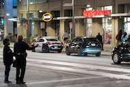 Gwendolyn Pipkins (left), the mother of Anthony Egeonu, talks with a Dallas police officer...
