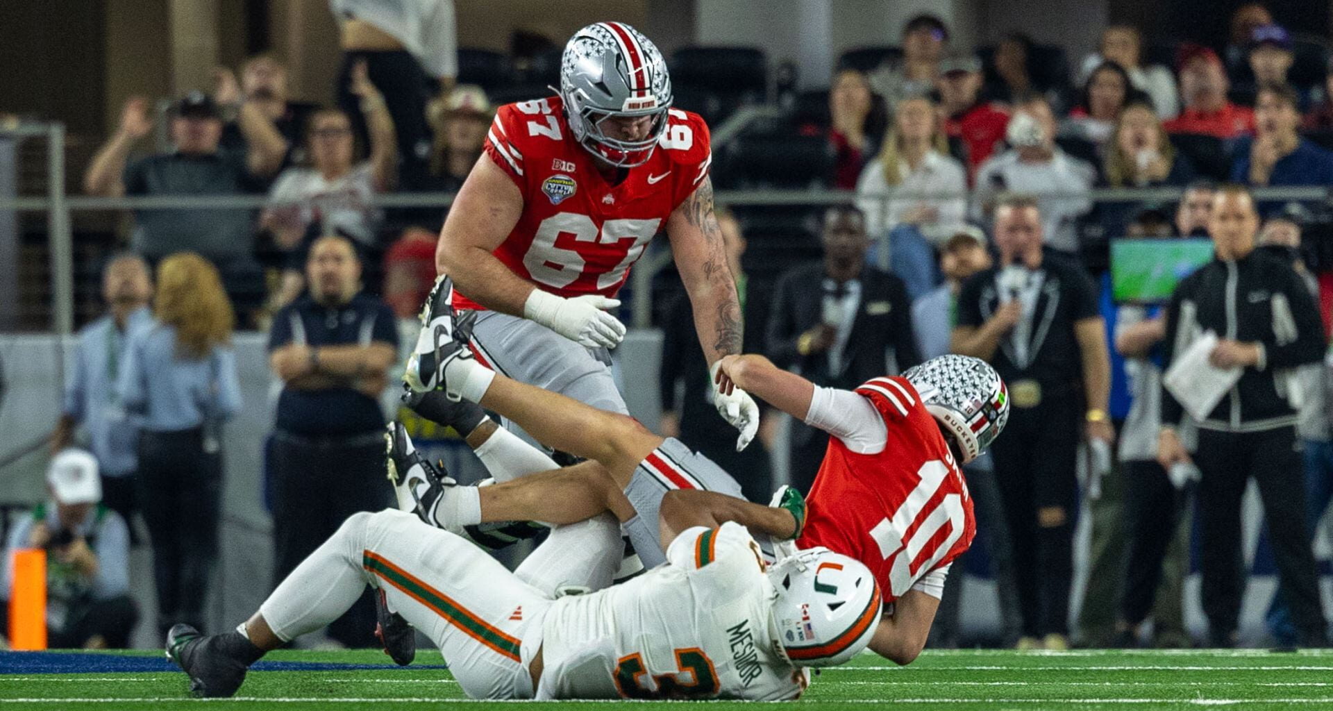 Miami defensive lineman Akheem Mesidor (3) sacks Ohio State redshirt freshman quarterback Julian Sayin (10) during the game Wednesday. The No. 2 Buckeyes lost to the No. 10 Miami Hurricanes 24-14 at the Cotton Bowl in Arlington, Texas. Credit: Sandra Fu