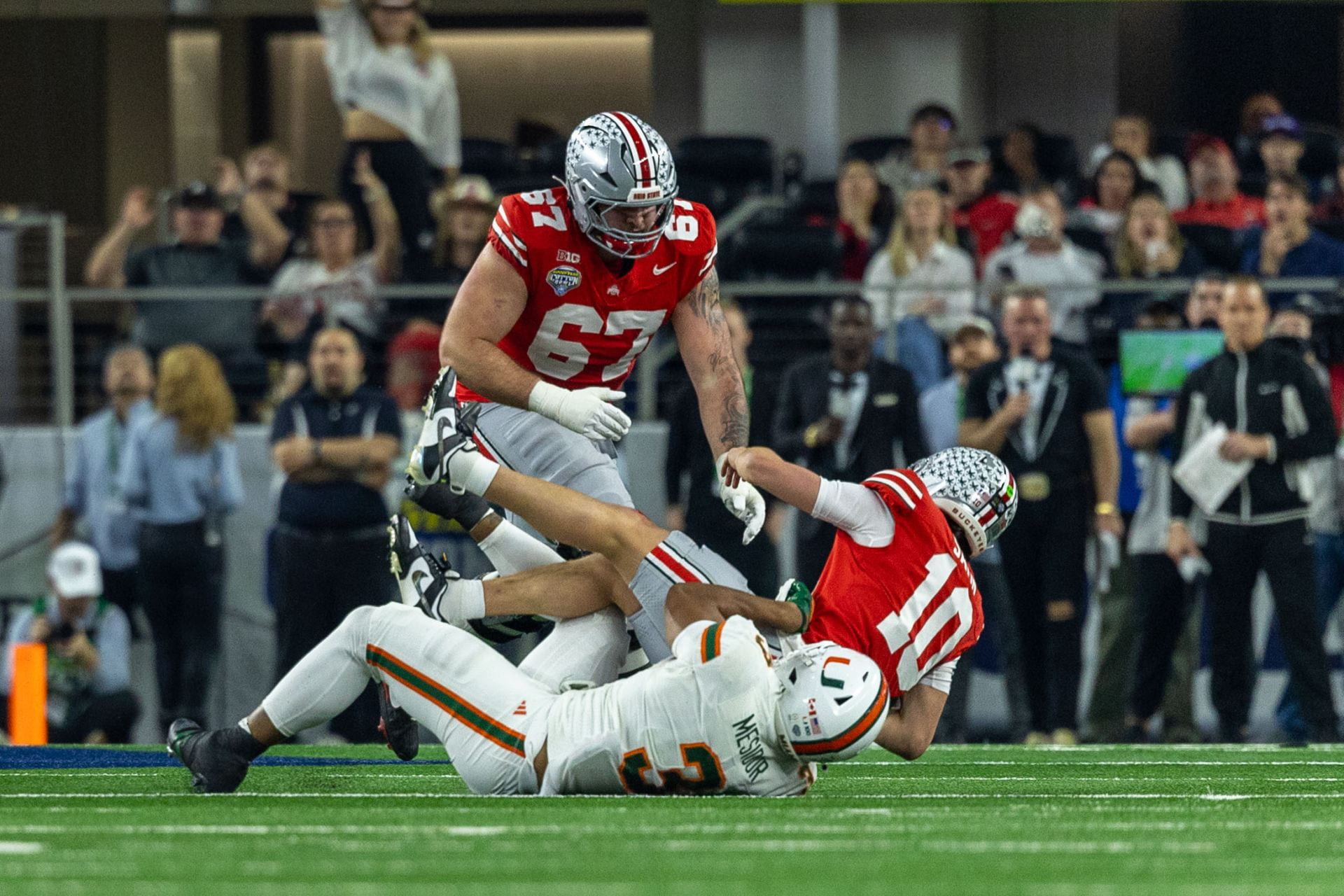 Miami defensive lineman Akheem Mesidor (3) sacks Ohio State redshirt freshman quarterback Julian Sayin (10) during the game Wednesday. The No. 2 Buckeyes lost to the No. 10 Miami Hurricanes 24-14 at the Cotton Bowl in Arlington, Texas. Credit: Sandra Fu | Managing Photo Editor