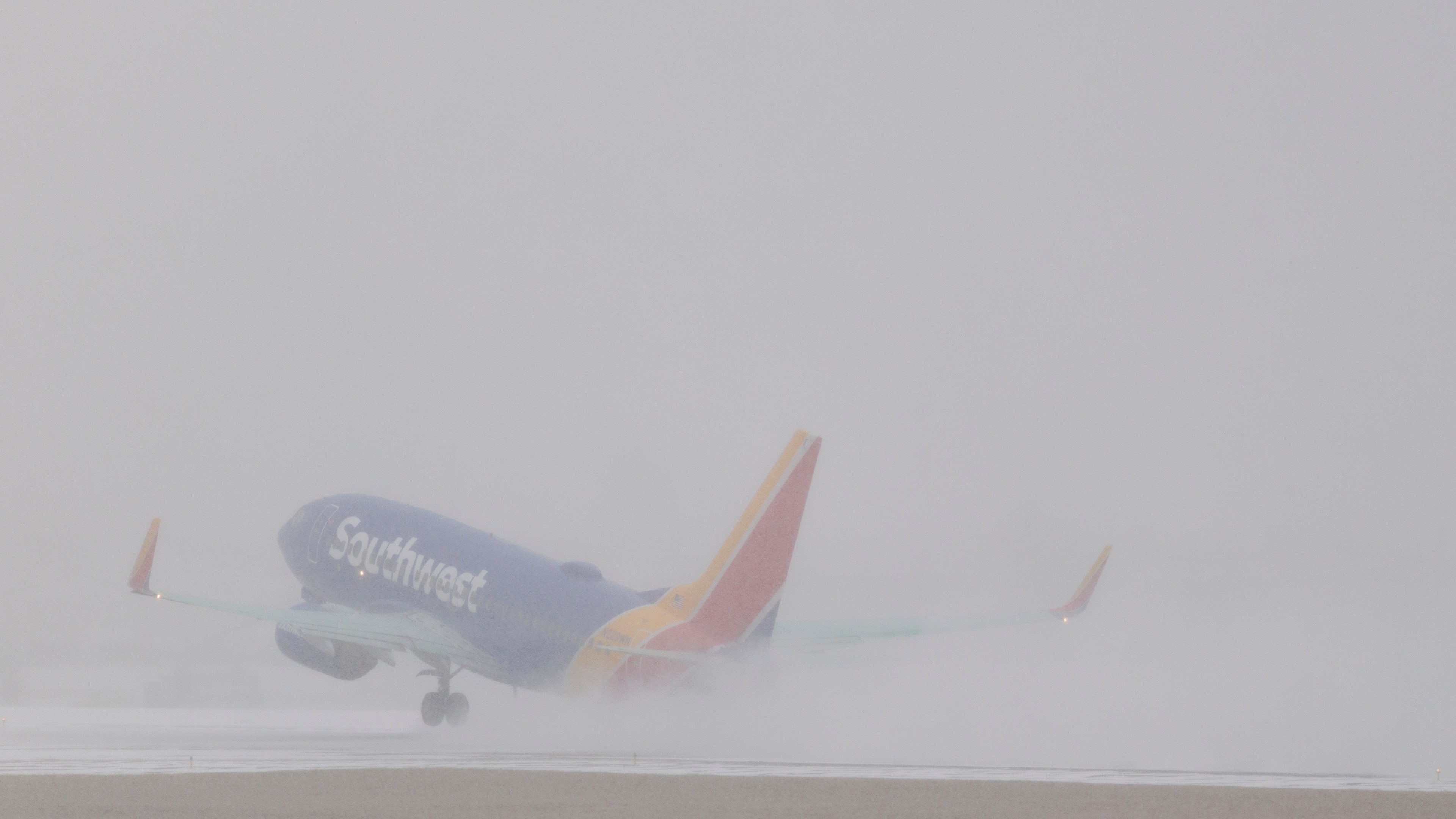 A Southwest Airlines flight takes off at Nashville International Airport as snow falls on Jan. 24, 2026 in Nashville, Tennessee.