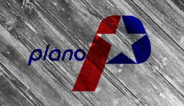 Flag of the city of Plano, Texas on a background of a wooden fence