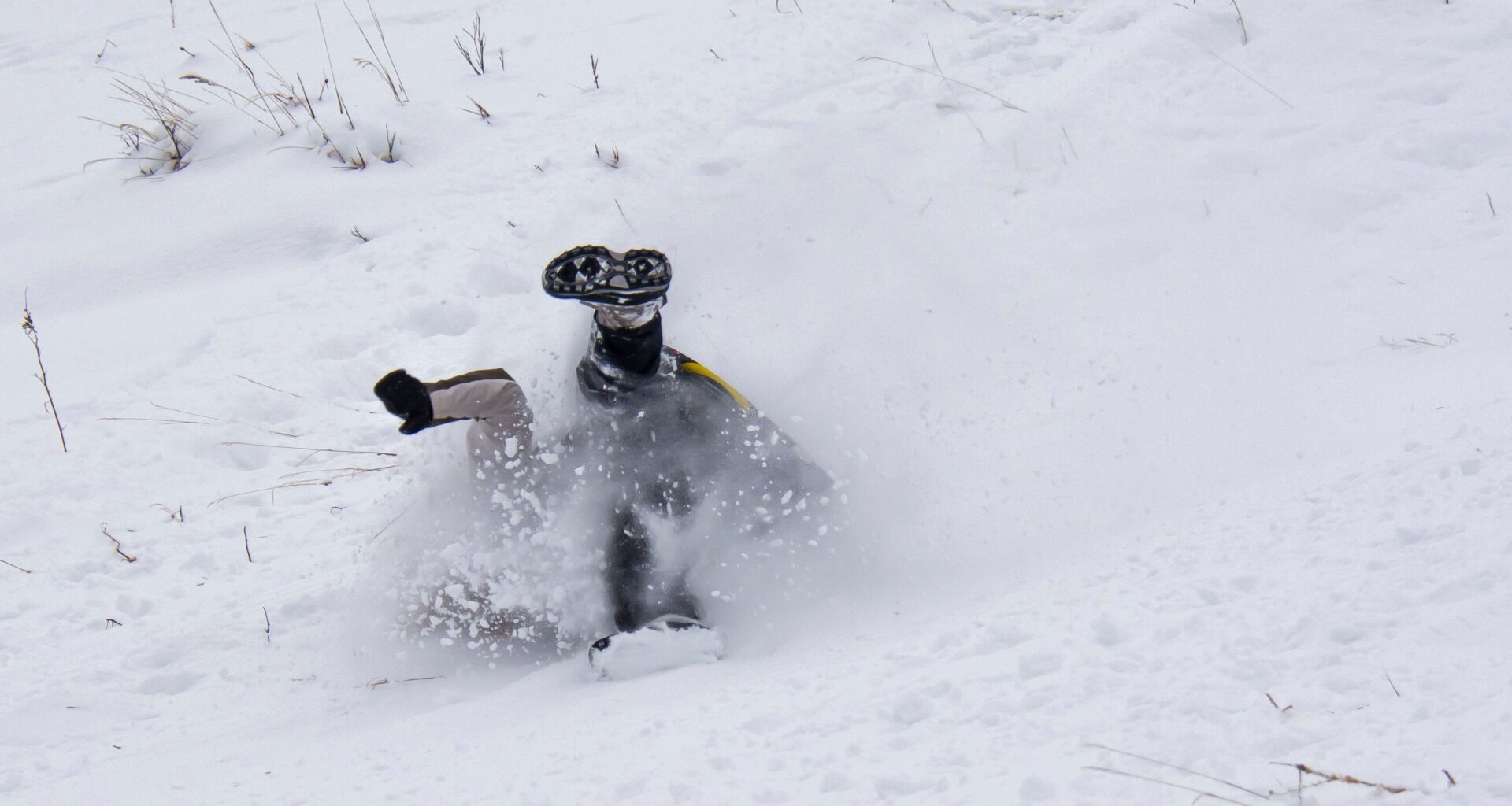 Sledder wipes out going down a hill