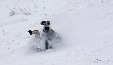 Sledder wipes out going down a hill