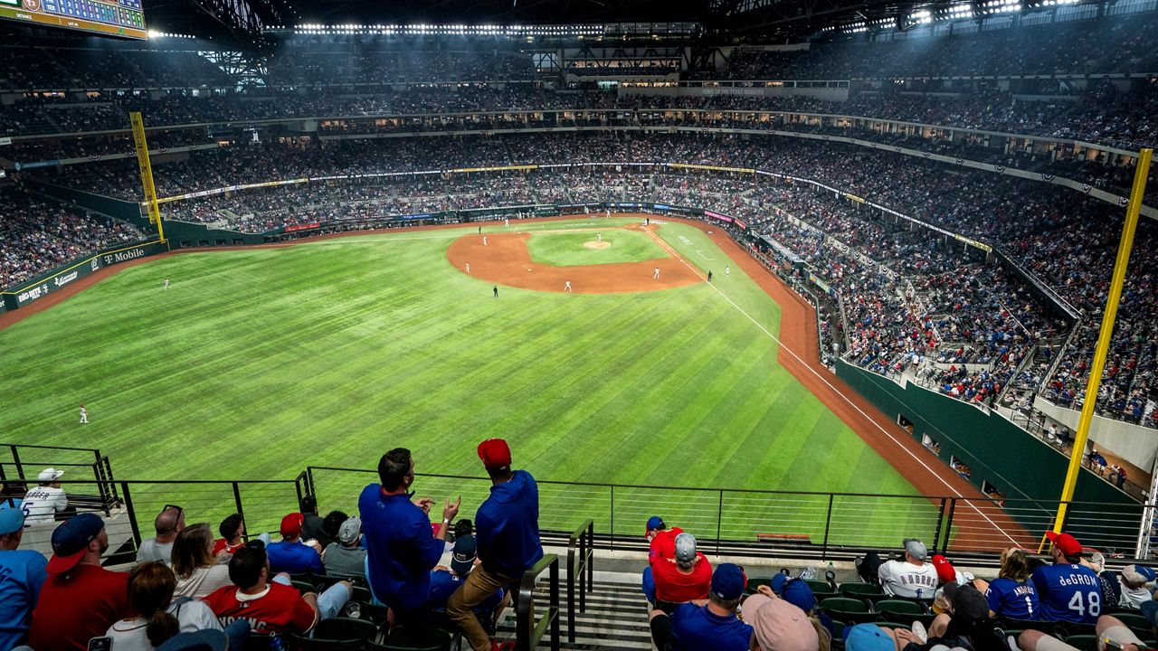 Fans watch an opening day baseball game between the Texas Rangers and the Philadelphia Phillies at Globe Life Field Thursday, March 30, 2023, in Arlington, Texas. (AP Photo/Jeffrey McWhorter)