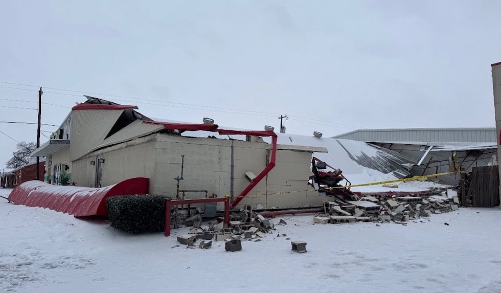 A storage building at an auto body shop in Gainesville collapses on Jan. 24, 2026.