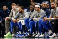 Dallas Mavericks forward Cooper Flagg (32), left, sits on the bench during the first half of...