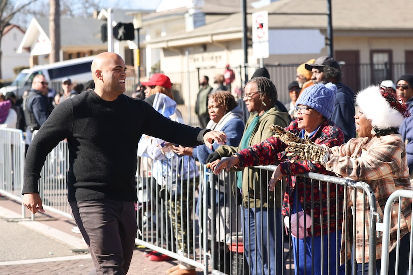 Former United States Representative Colin Allred greets the crowd during MLK Day parade, on...