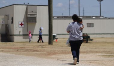 Immigrants seeking asylum walk at the ICE South Texas Family Residential Center, Aug. 23, 2019, in Dilley, Texas. (AP Photo/Eric Gay)