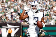 Dallas Cowboys wide receiver George Pickens (3) waves to the crowd as he runs off the field...