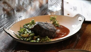 The new menu at Tinie's features a seared filet steak served over a mole that has a rich corn flavor. (Photo by Burciaga Hospitality Group)