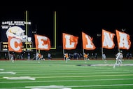 Celina students run with flags after a touchdown during the first half of a Class 4A...