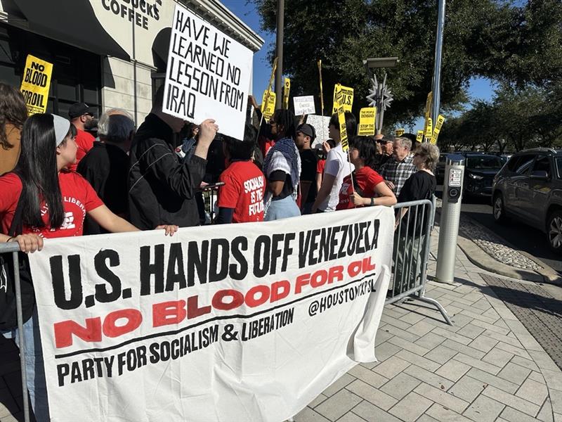 Protesters line the intersection of Westheimer Road and Post Oak Boulevard to demonstrate against U.S. intervention in Venezuela.