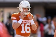 Texas quarterback Arch Manning (16) warms up before an NCAA college football game against...